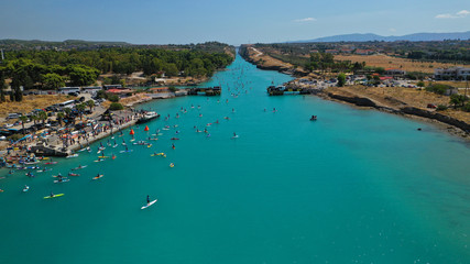 Fototapeta na wymiar Aerial bird's eye view photo taken by drone of stand up paddle surfers in annual SUP crossing competition in Corinth Canal, Greece