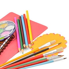 Pencils, paints, notebooks and other stationery isolated on a white background.