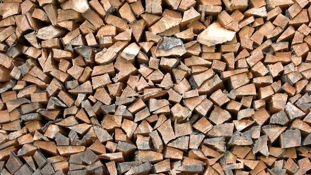 Chopped firewood background. Stacked dry firewood close up. Natural wooden background.