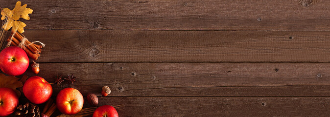Autumn corner border banner of apples and fall ingredients on a rustic wood background with copy space © Jenifoto
