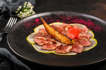 duck meat carpaccio with pear flambe (tasty snack, aperitif) menu concept. food background. copy space. Top view