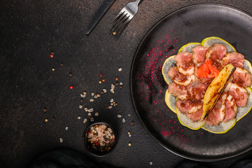 duck meat carpaccio with pear flambe (tasty snack, aperitif) menu concept. food background. copy space. Top view