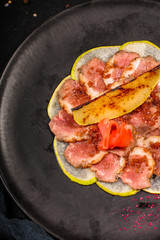 duck meat carpaccio with pear flambe (tasty snack, aperitif) menu concept. food background. copy space. Top view