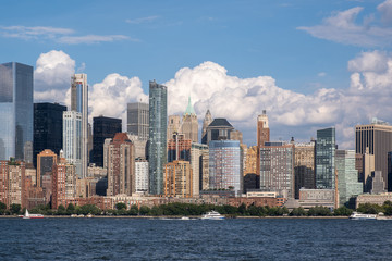 Lower Manhattan skyline with boat and ferry on Hudson river view from Liberty State Park in late summer