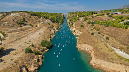 Fototapeta na wymiar Aerial bird's eye view photo taken by drone of stand up paddle surfers in annual SUP crossing competition in Corinth Canal, Greece
