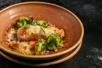 fish baked with vegetables (main course, white fish seafood, broccoli, carrots and others) menu concept. food background. copy space. Top view