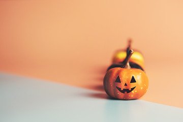 Happy Halloween, Pumpkin on pastel paper background.