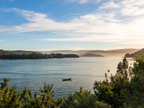 Small fishing boats, moored on the coast of the Valdivia River, in the town of Corral. Chile is a power in extractive fishing in the world. Valdivia, River Region, southern Chile.