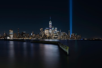 Fototapeta na wymiar Jersey City, NJ - USA - Aug 30 2019: The 9/11 Tribute in Lights temporary monument in lower Manhattan New York City view from New Jersey