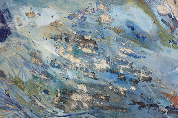 Peeling paint layers of an old fresco on a weathered wall surface