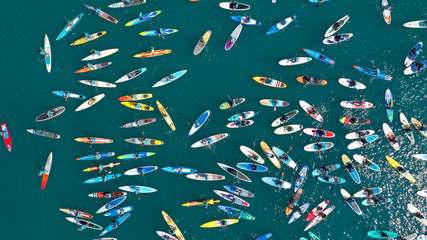 Aerial bird's eye view photo taken by drone of stand up paddle surfers in annual SUP crossing...