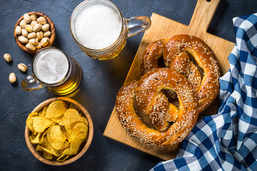 Oktoberfest food beer and bretzel on black.