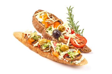 Bruschetta with tomatoes, cottage cheese, champignon mushrooms, olives and basil. Spanish Tapas and Pinchos, isolated on white background
