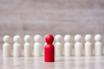 red leader businessman with crowd of wooden men. leadership, business, team, teamwork and Human resource management concept