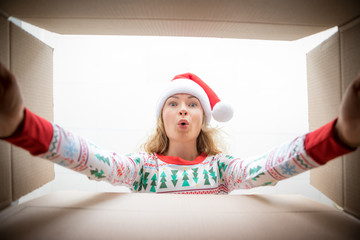 Surprised woman unpack Christmas gift box