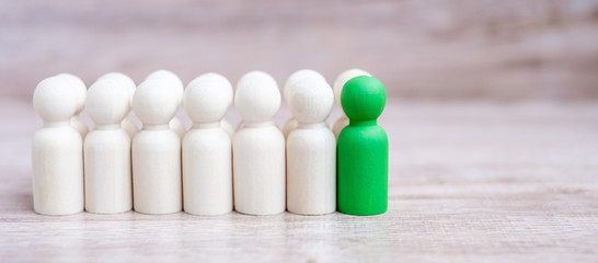 Green leader businessman with crowd of wooden men. leadership, business, team, teamwork and Human resource management concept