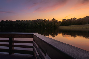 Sunset by the lake seen from a wood deck in the end of summer