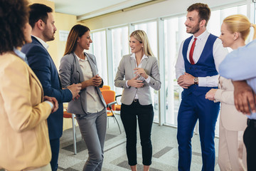 Business team having a meeting standing in the office. Selective focus.