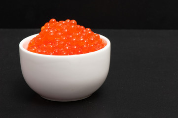 Red caviar in a saucer