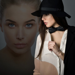 Young beautiful sexy woman in jacket, white shirt, bow-tie and hat over gray background. Fashion...