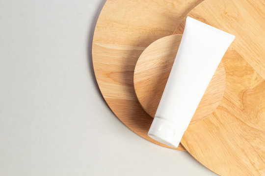 body lotion whitening cream tube of beauty makeup cosmetic product package mockup container with wood dish