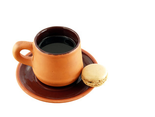 espresso in vintage clay cup with saucer and one macaron isolated on white