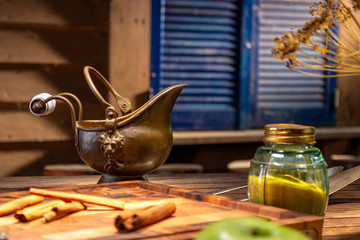 Copper vintage jug on a wooden table.
