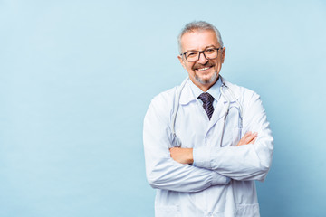 Cheerful mature doctor posing and smiling at camera, healthcare and medicine.