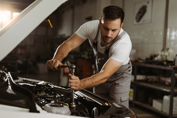 Mechanic is repairing an engine in the auto repair shop