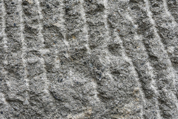 Grey rough textured stone surface with scratches and yellow spots. Empty rocky space with grunge surface. Building material. Natural stone textured background