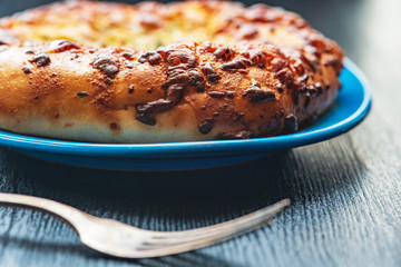 Bread with garlic and cheese on a dark wooden background. Photographed close-up.