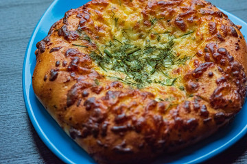 Bread with garlic and cheese on a dark wooden background. Photographed close-up.