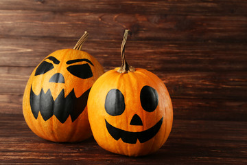 Halloween pumpkins on brown wooden background