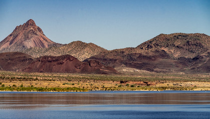 Alamo Lake State Park with purple mountains yellow grass and green flora in Arizona