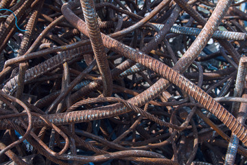 Industrial background. Rebar texture. Old rusty rebar for concrete pouring. Steel reinforcement bars. Dismantled construction rebar steel work reinforcement. Closeup of Steel rebars.