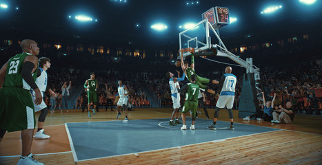 Fototapeta na wymiar Basketball players on big professional arena during the game. Tense moment of the game. Celebration