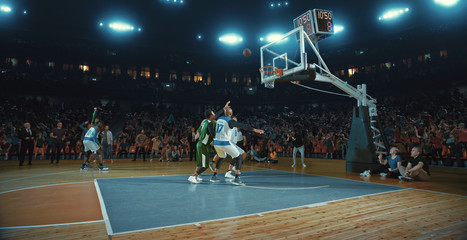 Basketball players on big professional arena during the game. Tense moment of the game. Celebration © haizon