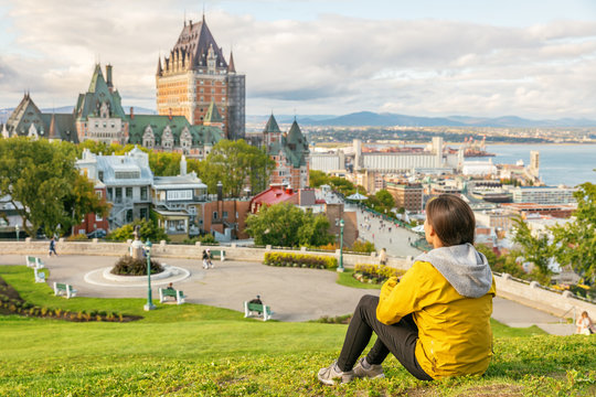 Canada travel Quebec city tourist enjoying view of Chateau Frontenac castle and St. Lawrence river in background. Autumn traveling holiday people lifestyle.