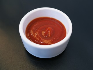 Top view of Chili sauce or tomato sauce to add flavor isolated on black background.