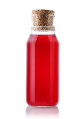 Red glass bottle of juice or compote on a white isolated background. Homemade lemonade carafe on a white background.
