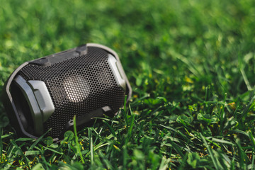 Portable speaker in the grass