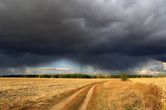 heavy clouds over dirty road in steppe