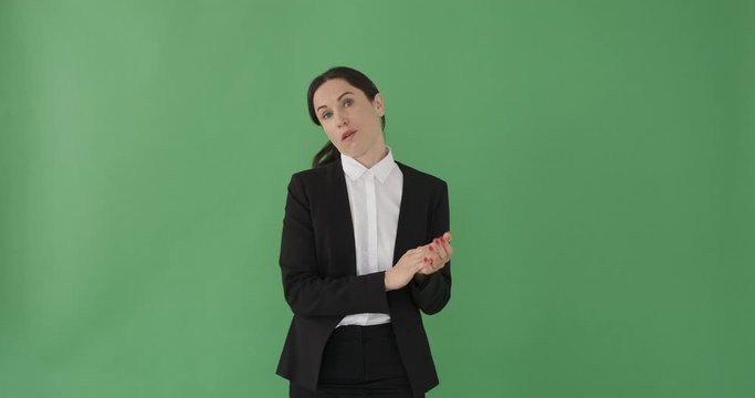 Upset businesswoman clapping hands over green background