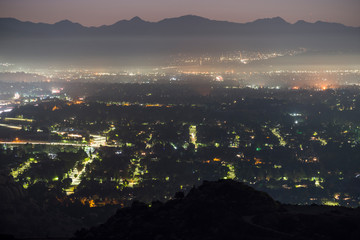 Predawn mountaintop view of foggy San Fernando Valley neighborhoods in Los Angeles, California.