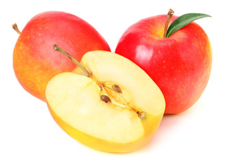 red apples with slices and green leaves isolated on a white background