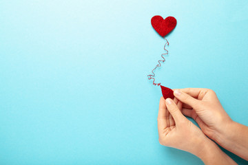 Blood donor. Hands with red heart and drop. Medical donation and blood transfusion.