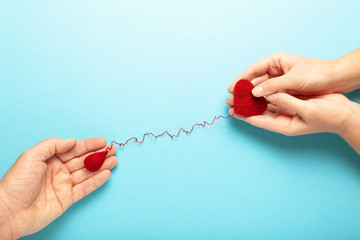 Blood donor. Hands with red heart and drop. Medical donation and blood transfusion.