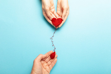 Blood donor. Hands with red heart and drop. Medical donation and blood transfusion.