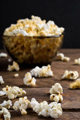 Air salty popcorn.A bowl of popcorn on a wooden table.Salt popcorn on the wooden background .  With space for text.Top view.popcorn texture.Chees .