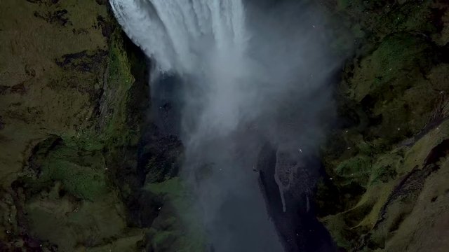 Aerial flight above Skogafoss, famous waterfall in southern Iceland. Most beautiful waterfall in Iceland during  spirng time. Green Iceland.